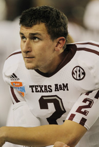 Texas A&M quarterback Johnny Manziel watches the action at the AT&T Cotton Bowl game in Cowboys Stadium in Arlington, Texas on January 24, 2013. Manziel reportedly autographed multiple pictures and had been paid for it, however there was no hard evidence of the money being paid to him. As a consequence, he was unable to play the first half of Texas A&M’s first football game against Rice to start the 2013-2014 season.