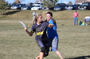 Senior Katie Mintle lunges to pass the disc past a Lakewood High School defender. In the semifinal game at Broomfield County Commons on Sunday, November 10th the Coyotes lost 15-6.