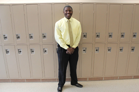 Chris Earls poses for a portrait in the downstairs B-Hall. Earls is an administrative intern who is shadowing principal Jerry Anderson.