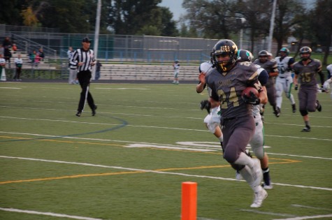 Monarch running back Philip Bubernak, number 24, runs the ball in for a touchdown during Friday night's game against Standley Lake. The Coyotes won with a final score of 43-7.