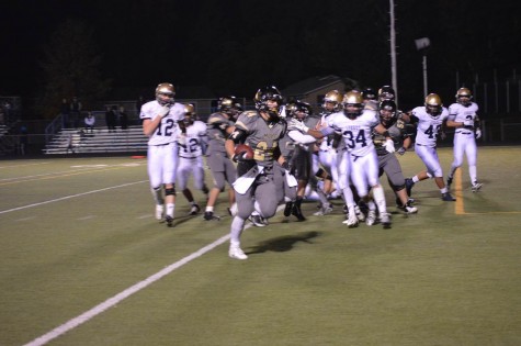 Running back Phillip Bubernak runs the ball in for an early touchdown in Friday night’s game against legacy. Victory evaded Monarch after a tightly matched game with a final score of 21-28.
