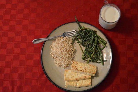 A vegan meal of tofu, brown rice, asparagus, and soy milk.