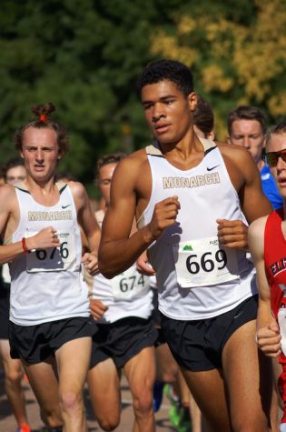 Senior Isaac Green (number 669) runs in a cross country meet.