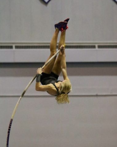 Soaring to new heights! Freshman Mia Manson executes a pole vault.
