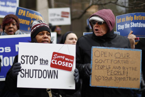 People rally to call for an end to the partial government shutdown in Detroit, Thursday, Jan. 10, 2019.