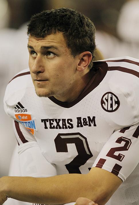 Texas+A%26M+quarterback+Johnny+Manziel+watches+the+action+at+the+AT%26T+Cotton+Bowl+game+in+Cowboys+Stadium+in+Arlington%2C+Texas+on+January+24%2C+2013.+Manziel+reportedly+autographed+multiple+pictures+and+had+been+paid+for+it%2C+however+there+was+no+hard+evidence+of+the+money+being+paid+to+him.+As+a+consequence%2C+he+was+unable+to+play+the+first+half+of+Texas+A%26M%E2%80%99s+first+football+game+against+Rice+to+start+the+2013-2014+season.+