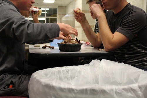 Competitors eat a roast chicken at the Thanksgiving Throwdown on November 22nd, 2013 in the student center at Monarch High School.