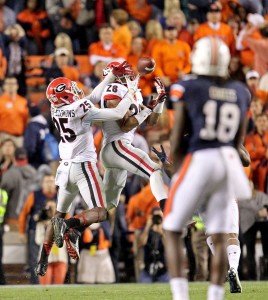 Tray Matthews (28) and Josh Harvey-Clemons (25) of the Georgia Bulldogs tip a pass, but Ricardo Louis of the Auburn Tigers makes the catch scoring the game-winning touchdown at Jordan-Hare Stadium in Auburn, Ala., on Saturday, Nov. 16, 2013. Auburn defeated Georgia, 43-38.