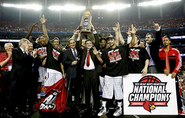 Louisville Cardinals head coach Rick Pitino celebrates with his team after defeating Michigan, 82-76, and winning the NCAA Men's Basketball Championship at the Georgia Dome in Atlanta, Georgia, Monday, April 8, 2013. 