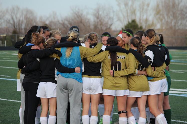 The+girls+soccer+squad+huddles+up+before+taking+the+field+for+second+half+action+against+Fairview+on+April+4%2C+2014+at+Monarch+High+School.