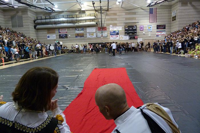 Teacher Kevin Lowe leans over to talk to Melissa Duplechin at last years homecoming pep-assembly. 