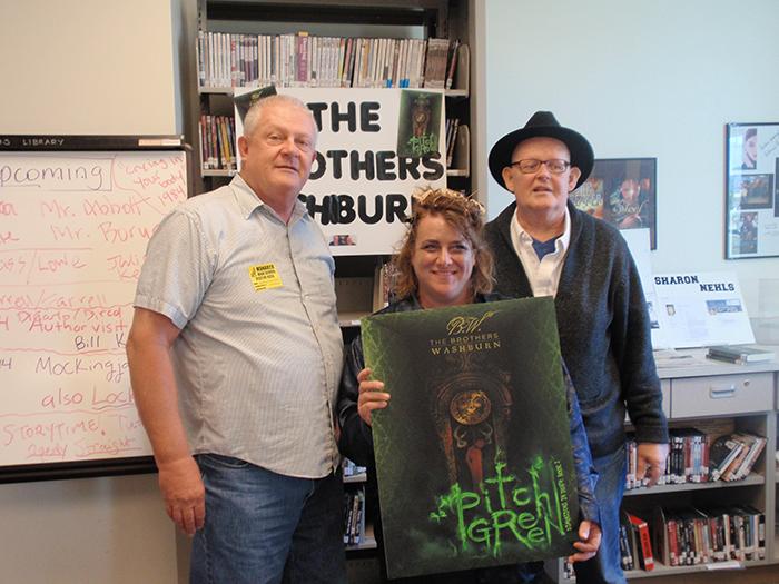 Prepare for scare! Berk and Andy Washburn stand next to Ms. Gerrish soon after arriving at Monarch. The two authors came on Friday to talk about their book, Pitch Green. 
