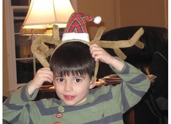 My young cousin, Ryan Realejo, poses in reindeer ears at Christmas in 2010. The Christmas outfits begin before you can even walk!
