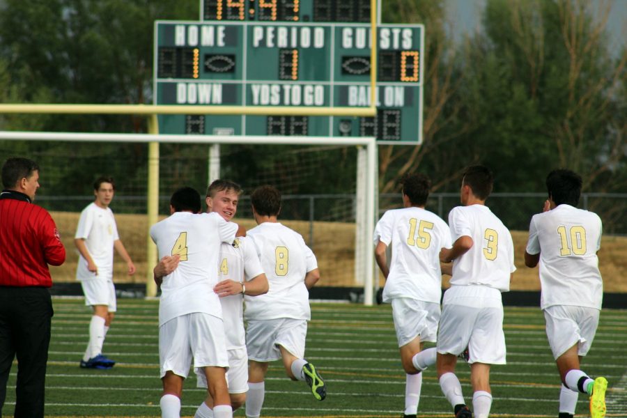 With grins on their faces, the Monarch boys soccer team celebrates after scoring their first goal of the game. 
