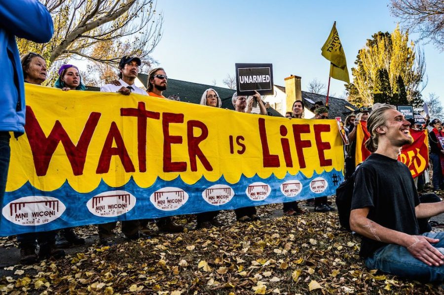 Water is Life. Water Protectors and Spiritual Leaders demonstrate outside the Governors Mansion in Bismarck, ND. Photo by Rob Wilson Photography