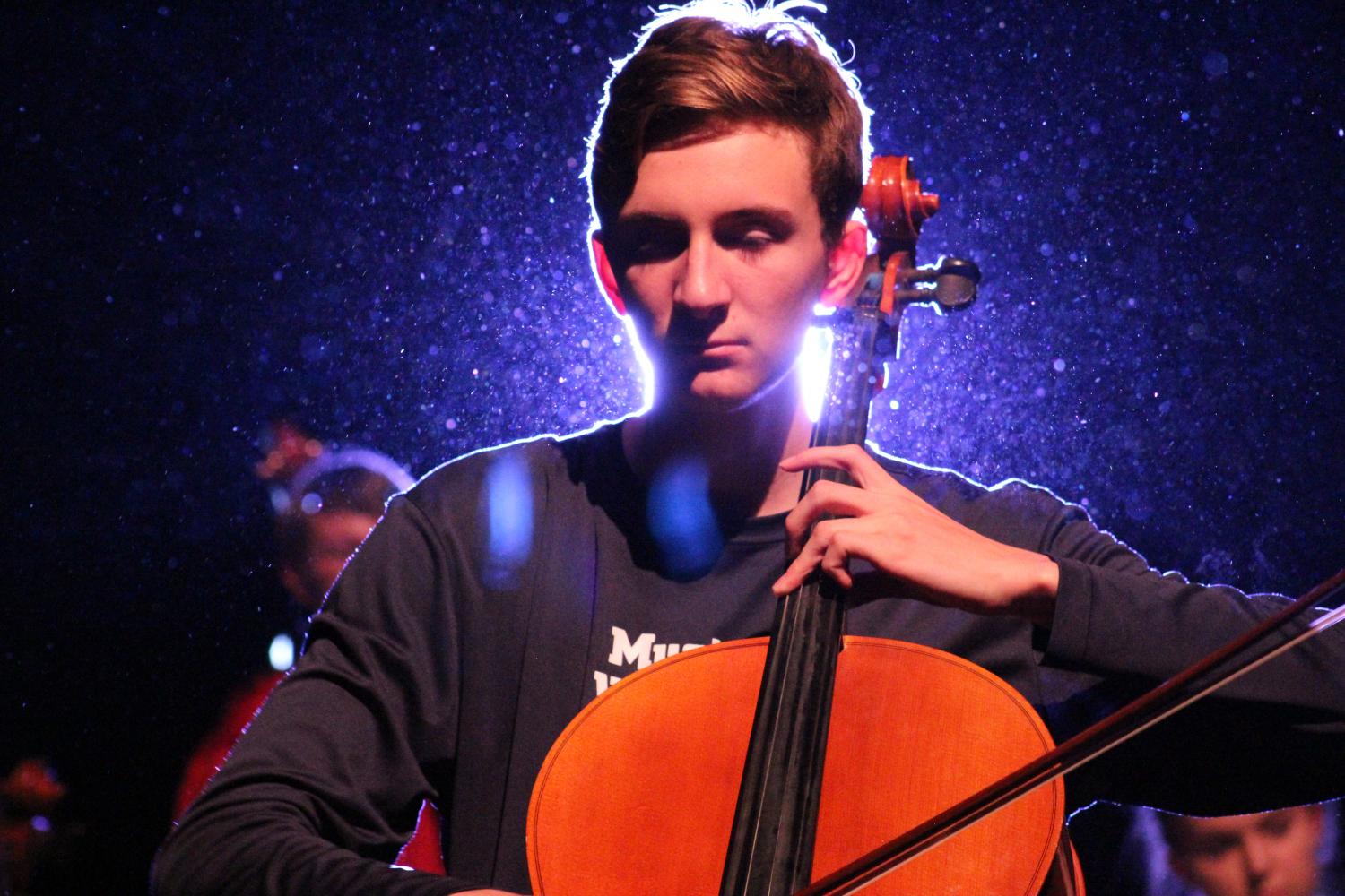 Sean Pike (12) plays his cello with ease during the combined orchestras performance of Paint it Black. 