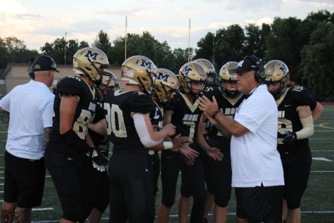 Coach Phil Bravo talks to his team before the game against Green Mountain on Aug. 27. He is retiring this year after a celebrated career.