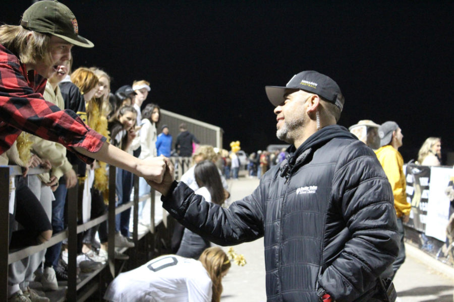 Campus security Steve Brown greets a student at the football game against Green Mountain on Oct. 28.