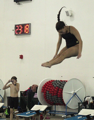 Mj Macias 23 preforms a front dive at swim practice. After moving from Mexico, she now dives for monarch