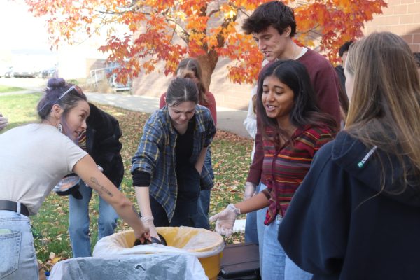 Eco Club Co-President Ashna Shah (12) works with other club members in a waste audit conducted by Eco-Cycle, gathering data from a sample of the school cafeteria’s trash cans. Students learned how to correctly distribute waste into compost, recycling, and landfill.