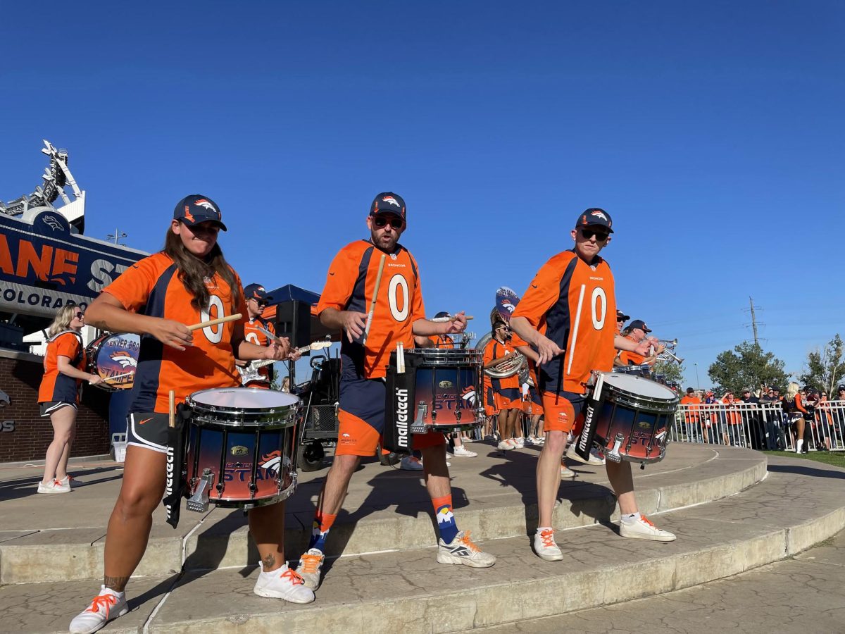 Tyler Vandermeer plays his part in the band for famous Broncos NFL team marching down the street displaying their skills. 